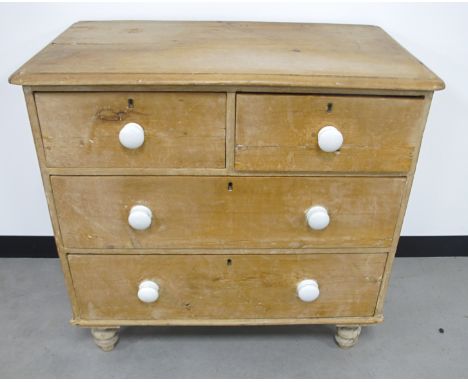 A 19th Century stripped pine chest of drawers, two short drawers over two long drawers, with white ceramic handles, raised on