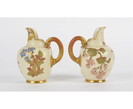 A pair of Royal Worcester flat-back jugs, each with with gold gilt and floral decoration on a cream ground, purple date code 