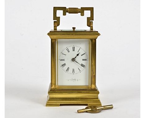 A late 19th Century French brass carriage clock, white enamel dial with Roman numerals, inscribed 'Exhibited by Collingwood &
