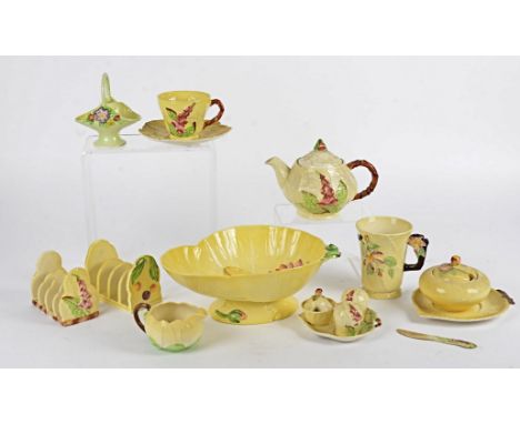 A quantity of Carlton Ware predominantly in the yellow colourway with floral decoration, to include two toastracks, a tea pot