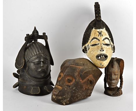 A collection of African masks, to include a Igbo maiden spirit mask, a Kuba mask, Makonde mask, Senufo mask, Senufo figure, f