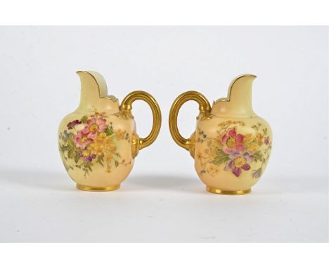 A pair of Royal Worcester blush ivory jugs,  with handpainted floral decoration and gilt, height 10.5cm, puce cipher and numb