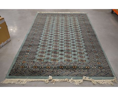 A Middle Eastern 20th Century woollen rug,  with a sequential geometric pattern to the central panel, bordered with micromosa