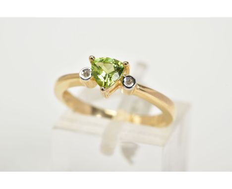 A 9CT GOLD PERIDOT AND DIAMOND RING, set with a central claw set, triangular cut peridot flanked with single cut diamond deta