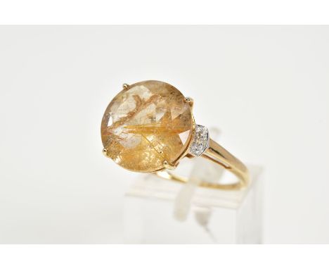 A 9CT GOLD RUTILATED QUARTZ RING, designed with a claw set rutilated quartz, single cut diamond detailed shoulders, open work