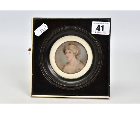 A MINIATURE PORTRAIT WITHIN A WOODEN FRAME, the black wooden frame with an outside ivory panel surround, features a circular 