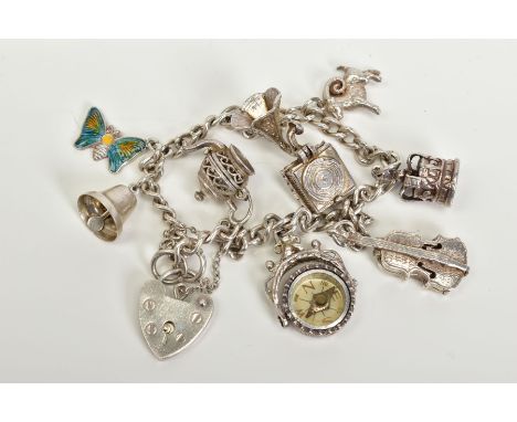 A SILVER CHARM BRACELET, with eight attached charms such as a small fob compass, violin, bell, crown, enamelled butterfly, op