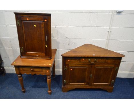 A REPRODUCTION OAK TWO DOOR CORNER CUPBOARD, width 95cm x depth 47cm x height 76cm and a matching smaller hanging corner cupb