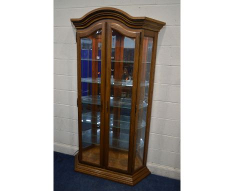 A TALL MODERN OAK TWO DOOR DISPLAY CABINET with bevelled glass panels, internal lighting and five shelves, width 123cm x dept