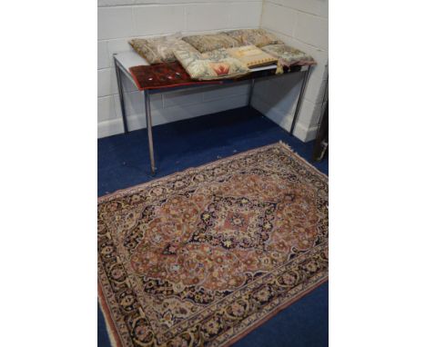 A LATE 20TH CENTURY WOOLLEN PINK GROUND RUG, together with six various tapestry cushions and a small red ground rug (8)
