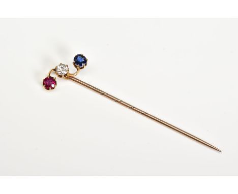 A YELLOW METAL GEM SET STICK PIN, set with a circular cut ruby, sapphire and round brilliant cut diamond, total estimated dia