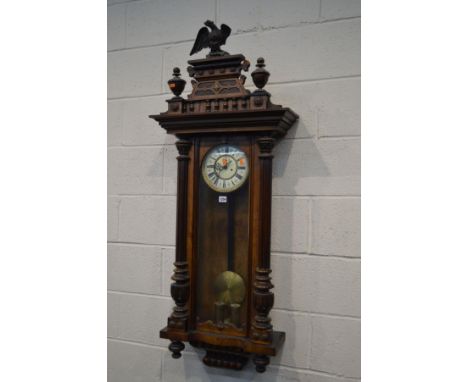A LATE 19TH CENTURY WALNUT VIENNA REGULATOR WALL CLOCK, with a wooden eagle pediment finials, half fluted columns to the door