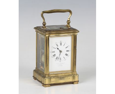 An early 20th century French lacquered brass carriage clock with eight day movement striking hours and half hours and repeati