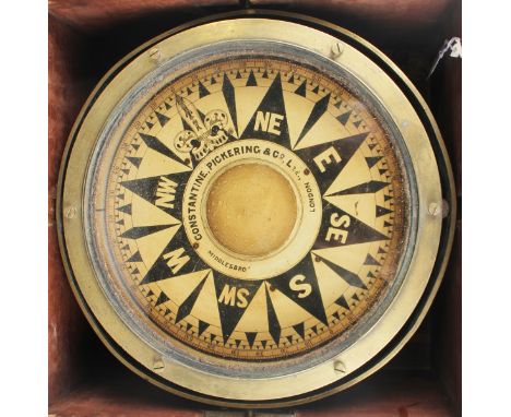 An early 20th century brass gimbal mounted marine/ship's compass, the 10-inch black and white printed circular dial detailed 