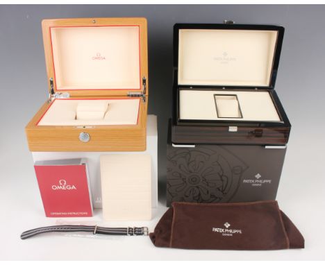 A Patek Philippe wood effect wristwatch case, length 23.5cm, with outer card box, and an Omega wood effect wristwatch case, l