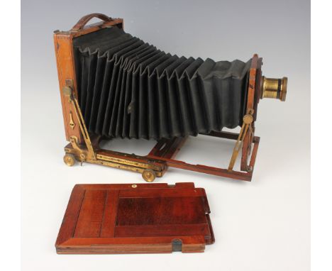 An early 20th century Houghton 'Triple Diamond' mahogany and gilt lacquered brass half plate camera with black bellows and a 