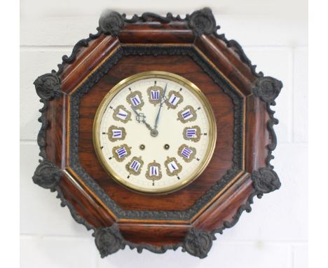 A late 19th century simulated rosewood octagonal tableau comtoise wall clock with eight day two train movement striking on a 