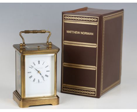 A 20th century lacquered brass cased carriage clock with eight day movement striking hours and half hours and repeating on a 