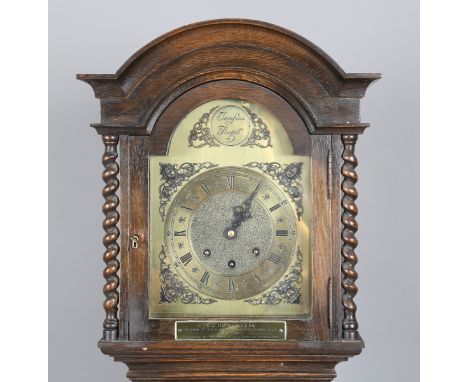 A George V oak diminutive longcase clock with eight day movement chiming on gongs, the brass breakarch dial with boss above a