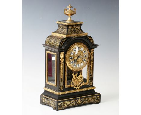 A late 19th century French gilt metal mounted ebonized and brass boulle cased mantel clock with eight day movement striking o