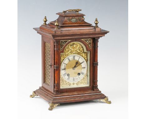 A late 19th century brass mounted oak mantel clock with Lenzkirch eight day movement striking on a gong, the brass breakarch 
