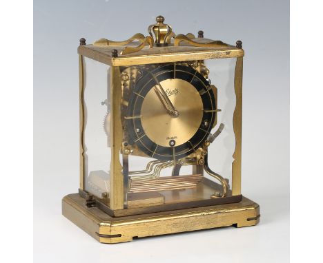 A 20th century German brass mantel clock with chiming movement, the circular dial inscribed 'Schatz German', the rectangular 