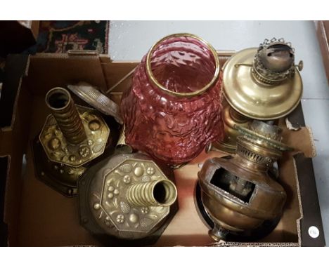 Pair of brass lamp bases and other lamp parts including a table lamp with red glass bowl