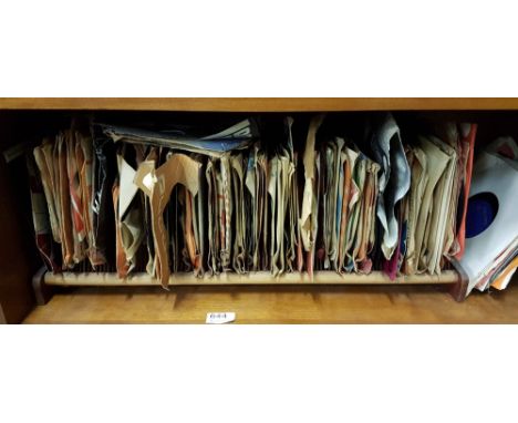 Shelf of vinyl singles, mainly pop music
