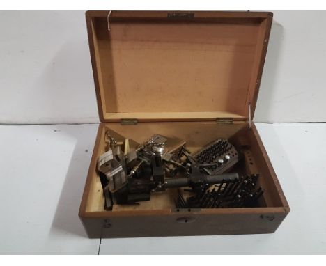 2 leather punches with accompanying tools in oak box