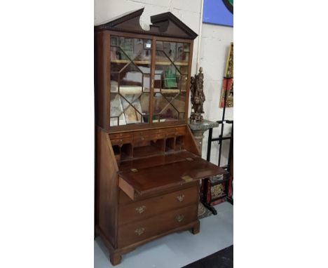 19thC Mahogany Bureau Bookcase, the arched pediment over two glazed doors enclosing shelves and a fall front bureau with 4 dr