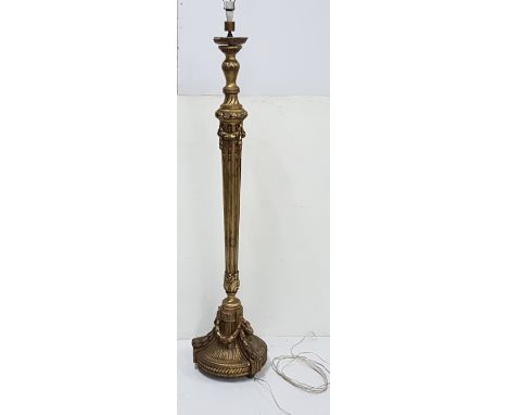 Late 19thC carved gilt wood Standard Lamp, electrified, the torch-shaped central column decorated with swags and sheaf-of-whe