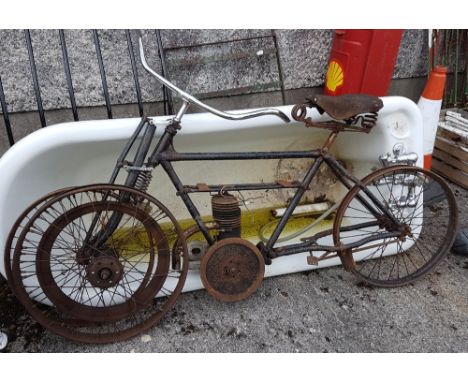 Old motor bike frame, with headlamp and part of an engine, Brooks saddle