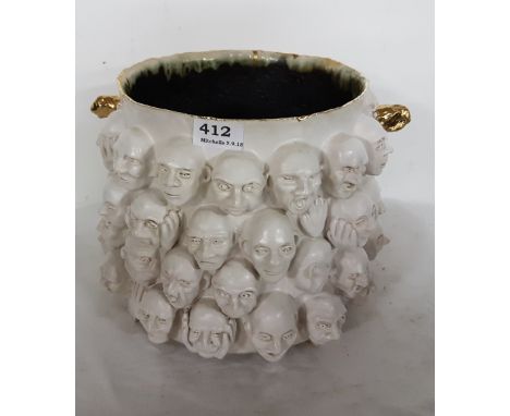 ELEANOR SWAN “Are You Sure”, a Ceramic Jardinière, painted white, decorated with the  raised heads of men, gold handles, sign