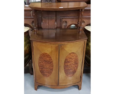 Edwardian Bowfront Side Cabinet, the raised upper shelf supported on turned columns, two doors below enclosing  shelves, sabr