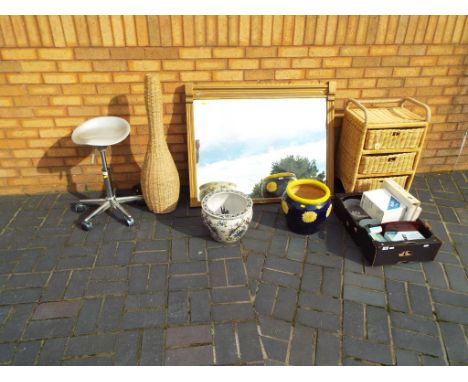 A good lot to include an over mantel mirror, approximately 86 cm x 107 cm, a wicker lamp, a wicker chest of three drawers, gl