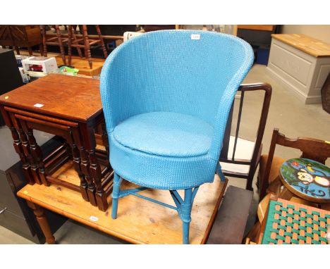 A blue loom tub shaped chair 