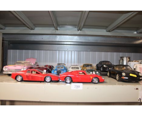 A quantity of model vehicles including a pink Cadillac, Ferraris etc. 