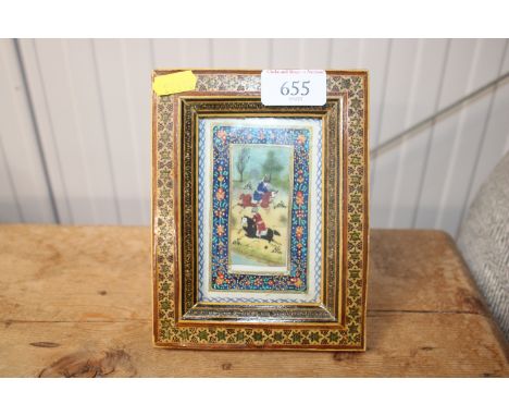 An Indian polo playing scene in decorated easel frame 