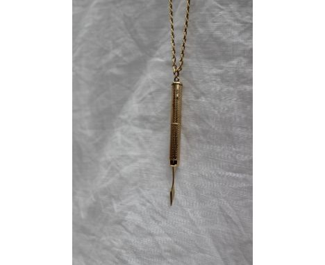 A 9ct gold propelling toothpick, approximately 6 grams, on an 18ct yellow gold long chain, approximately 13 grams, 73cm long