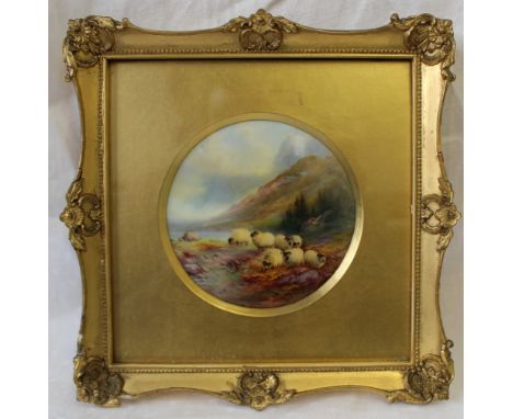 A Royal Worcester porcelain plaque of circular form, painted with sheep by a lock with mountains beyond, signed by Harry Davi