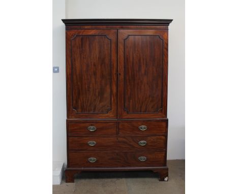 A 19th century mahogany linen press, the moulded cornice above a pair of panelled doors enclosing linen slides, above two sho