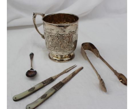 A Victorian silver christening mug, with scroll decoration on a pedestal foot, together with a pair of silver sugar nips, a s