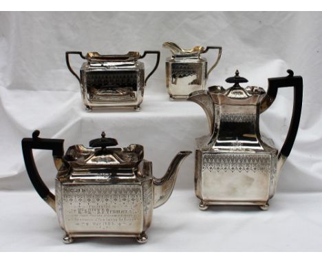 An Edward VII silver four piece teaset, of rectangular form decorated with swags, comprising hot water pot, teapot, cream jug