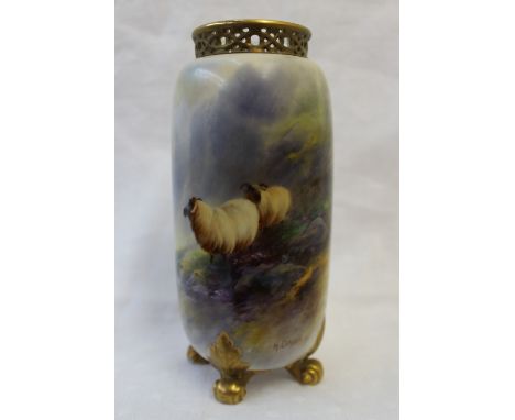 A Royal Worcester porcelain vase of cylindrical form with a reticulated top on four leaf capped scrolling feet, painted with 