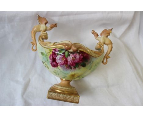 A Royal Worcester twin-handled pedestal vase of oval form with dragon handles painted with wild roses signed Roberts on a squ