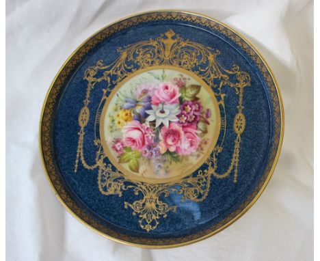 A Royal Worcester porcelain dish, with a shallow rim, painted to the centre with garden flowers to a gilt highlighted powder 