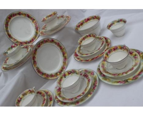 A Royal Worcester porcelain part tea service, transfer and infil decorated with red and yellow flowers, comprising six tea cu