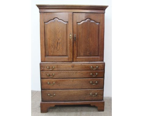 A 19th century mahogany linen press / secretaire, the moulded cornice above a pair of cupboard doors enclosing linen slides, 