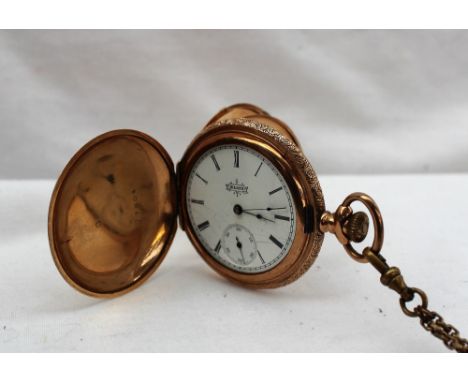 An Elgin National Watch Co. 14k yellow gold hunter pocket watch, the case profusely decorated with flowers and leaves in thre