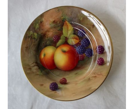 A Royal Worcester porcelain side plate painted with apples and blackberries to a naturalistic ground, signed A Shuck, puce ma